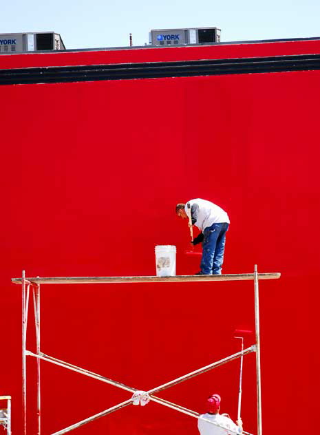 Workers repainting the Geisha House, formerly the Studio Caf, bright red, as it had faded to pink - Hollywood Boulevard at Cherokee