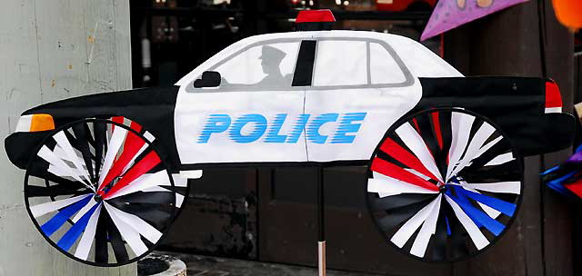 Wind-driven figures for sale on the Redondo Beach Pier - police car