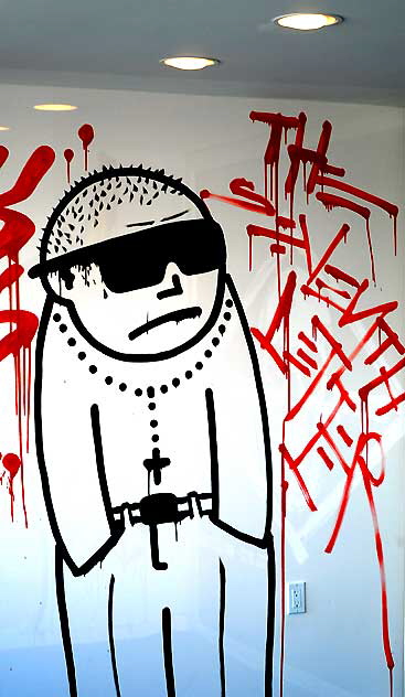 Gang member with hands in pockets - graphic in the window of a Fairfax District art gallery