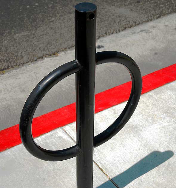 Bicycle rack and red curb