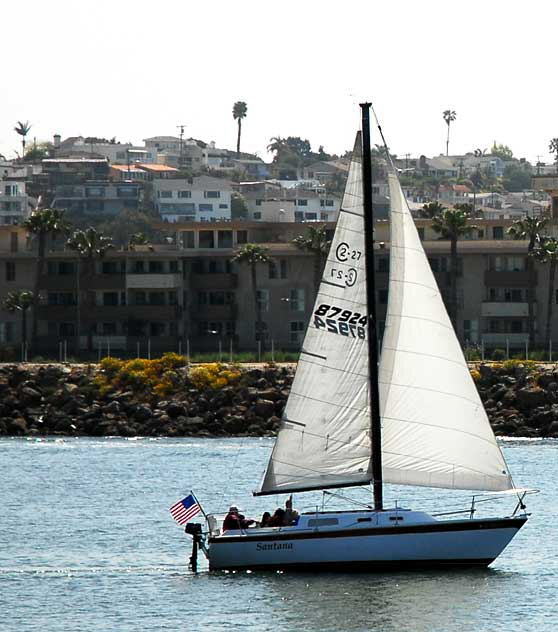 Sloop heading out sea - the channel that leads to the open Pacific at Marina del Rey