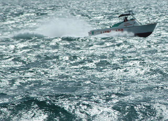 Los Angeles County Fire Department lifeguard boat blasting through the chop off Santa Monica 