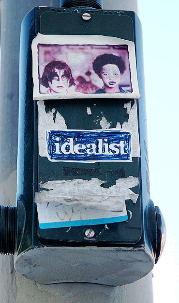 Below the billboard, the remaining idealists -