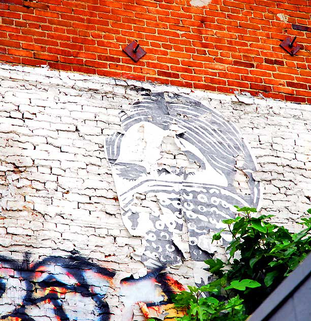 Masked woman bandit graphic on brick wall, 5600 block of Hollywood Boulevard