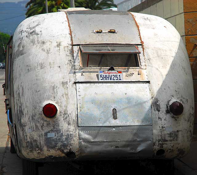 Antique gray streamlined bus parked on Gower, on the west side of Paramount Studios