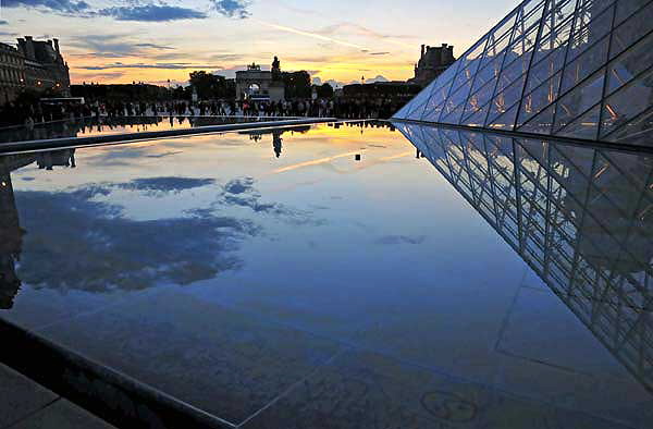 The Louvre - "Thousands of folks were standing in line to enter via the Pyramid which is copyrighted and you must have permission to merely gaze upon it so I am not admitting I took any photos of it, nossir. I took photos of its reflection in the various pools surrounding it. Reflections are very temporary items, unsuitable for copyrighting. If there is no water handy it is okay to use glass, as in windows. "