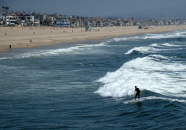 Manhattan Beach, a surfer dude, riding the waves