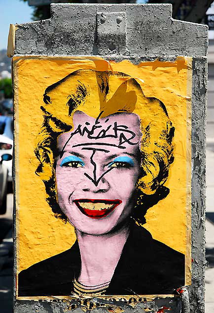 Yellow poster on utility box at Melrose and La Brea, West Los Angeles - Faith Ford, exaggerated, and poster defaced