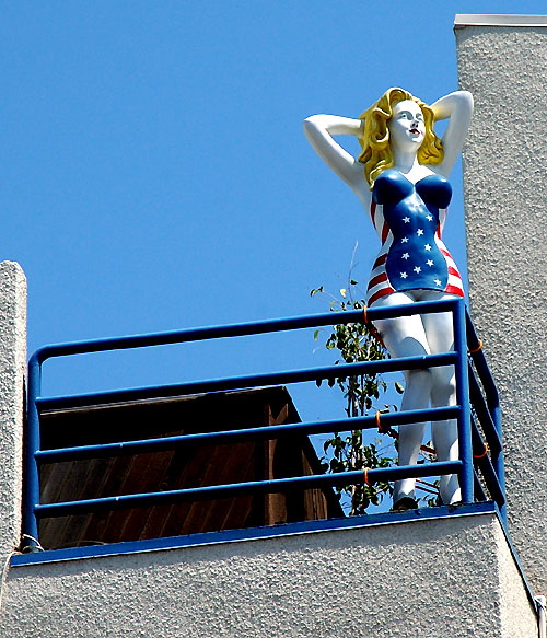 Blond swimsuit all-American manikin on balcony, Driftwood and Speedway, Venice Beach