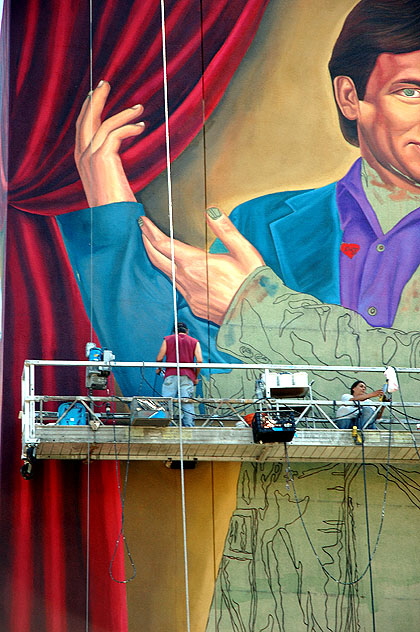 This is the north wall of Hollywood High School, as they add another alumnus to the mural that starts on the east wall with Judy Garland.  This seems to be John Ritter.