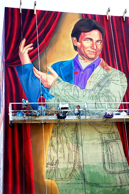 This is the north wall of Hollywood High School, as they add another alumnus to the mural that starts on the east wall with Judy Garland.  This seems to be John Ritter.
