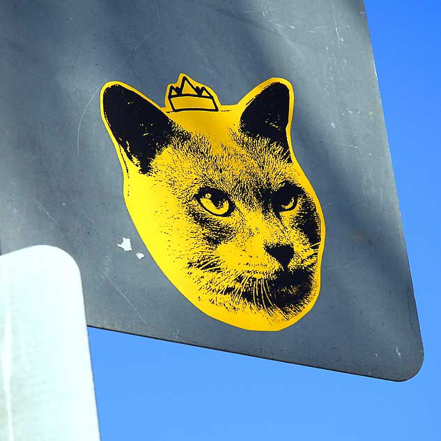 Yellow cat with crown, sticker on back of a street sign, Culver City