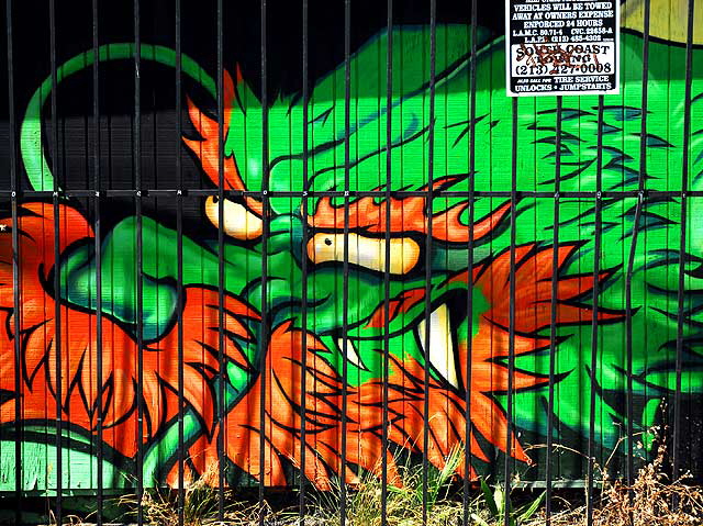 A dragon behind bars in a back alley, Melrose Avenue