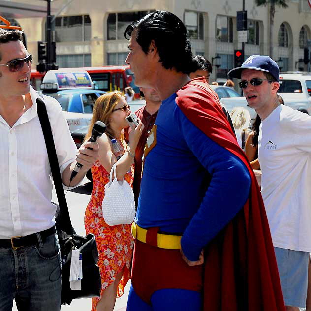 Superman impersonator being interviewed in front of Grauman's Chinese Theater, Hollywood Boulevard