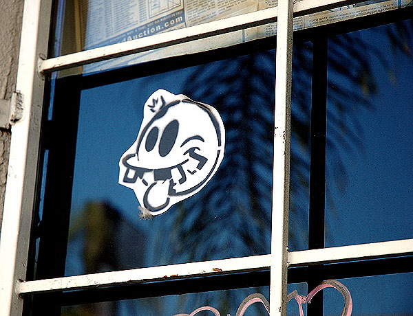 Face sticker on blue window, with palm, North Cahuenga Boulevard in Hollywood 