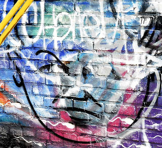 Painted brick wall in a back alley off Albert Kinney Boulevard, Venice, California