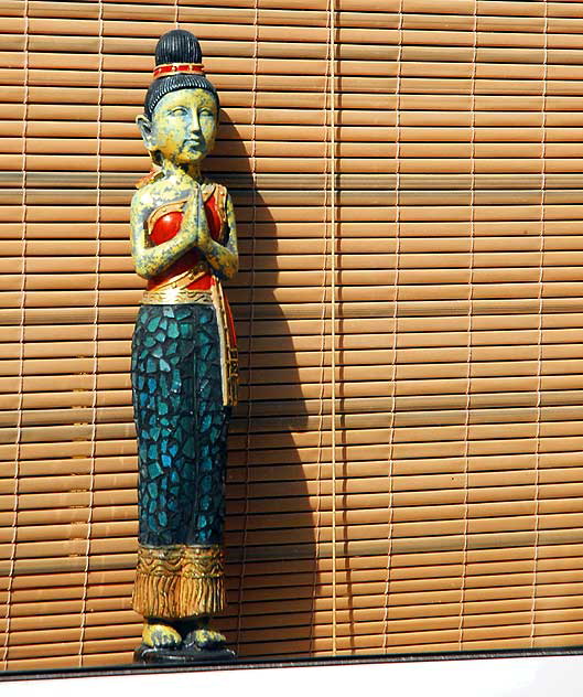 Thai figure in motel office window, Ocean Park Boulevard