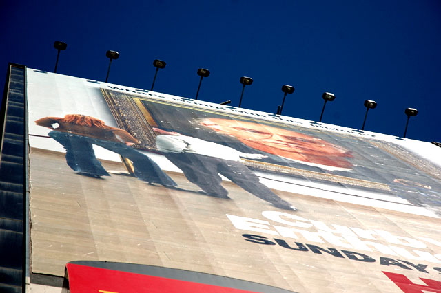 A west-facing building wrap from HBO, advertizing "Curb Your Enthusiasm" -