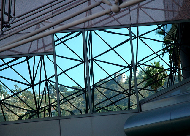 the Hollywood Hills, where the directors and cinematographers and celebrities live, framed by the framing at the entrance to the Director Guild of America headquarters on Sunset Boulevard at Harper