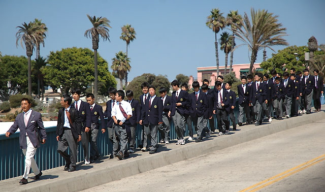 Asian schoolboys starting a tour of the Santa Monica pier 