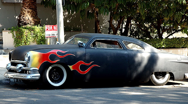 1953 Mercury coupe in flat black primer with the flames at the wheel wells