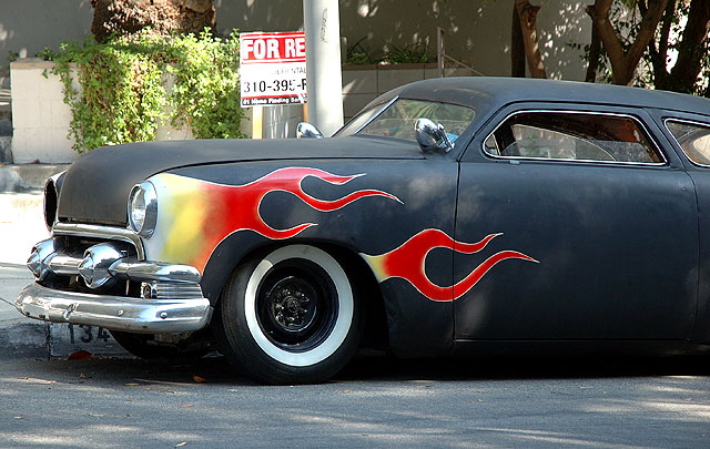 1953 Mercury coupe, in flat black primer with the flames at the wheel wells, chopped and channeled and done up in the manner of Ed "Big Daddy" Roth