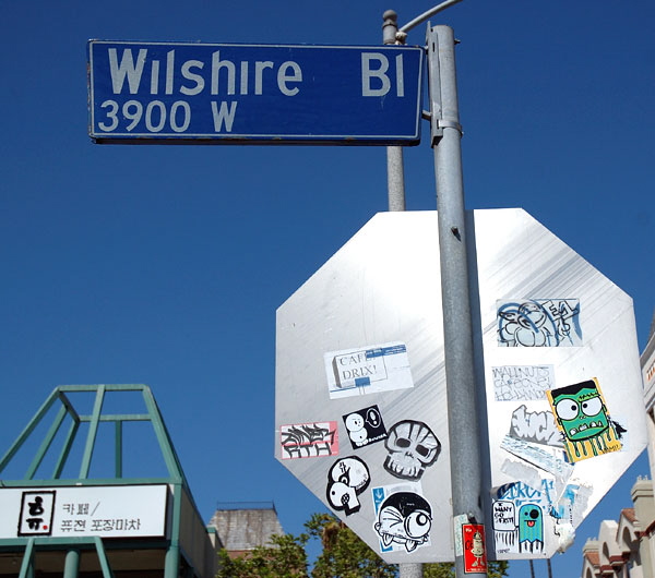 Wilshire Boulevard stop sign with stickers