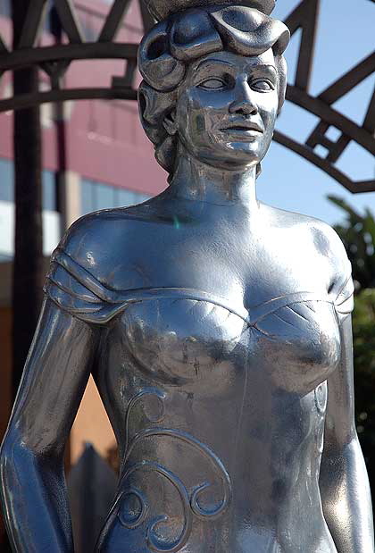 The Hollywood La Brea Gateway, the stainless steel gazebo on the southeast corner of Hollywood and La Brea, sometimes called the Four Ladies Statue, welcomes you to Hollywood. 