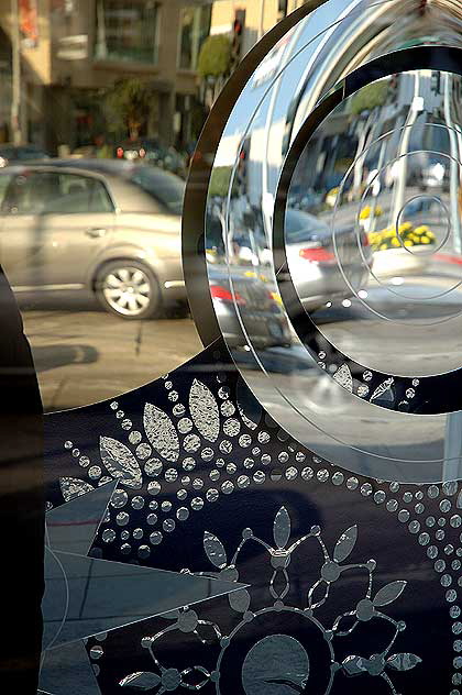 Christmas mirrors and snowflakes in window of Hugo Boss store, Sunset Plaza, West Hollywood