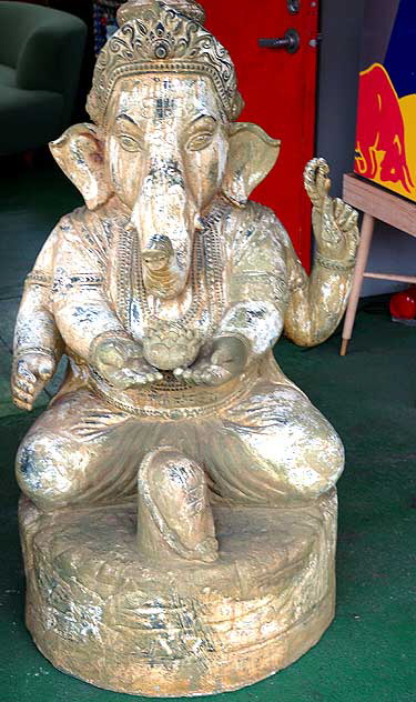 Elephant with four human arms offering a lotus blossom