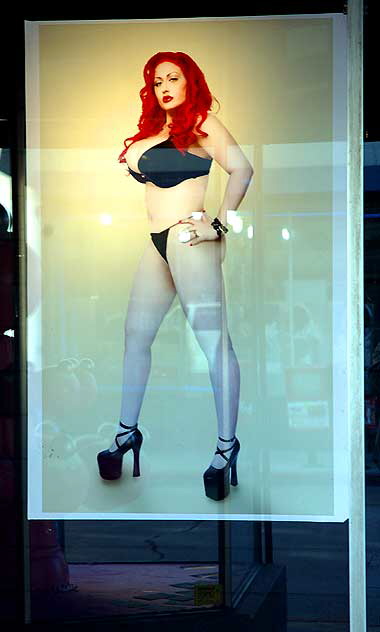 Redhead in heels under glass, Hollywood Boulevard