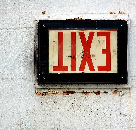 Upside-down exit sign at elevator in parking structure, Third Street Promenade, Santa Monica