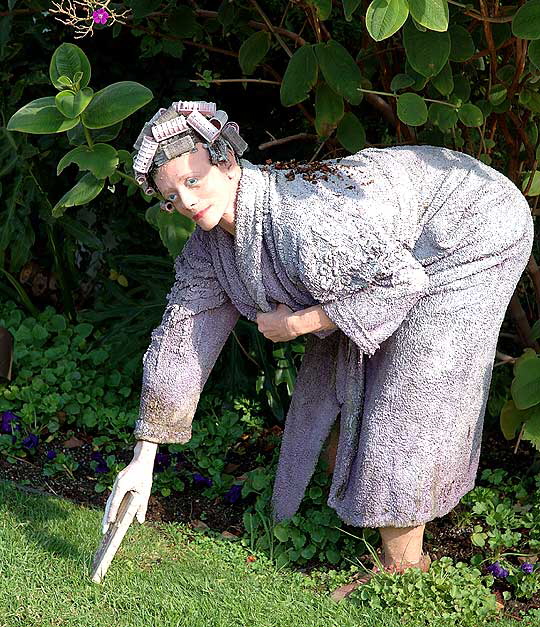 Hyper-realistic statue of woman in curlers retrieving the morning paper, curbside, North Bedford Drive, Beverly Hills