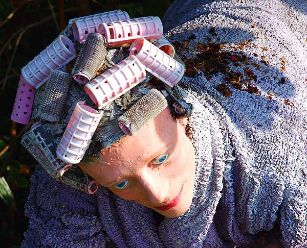 Hyper-realistic statue of woman in curlers retrieving the morning paper, curbside, North Bedford Drive, Beverly Hills