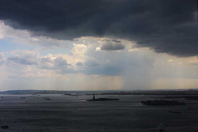 From high up in One World Trade Center, a thunderstorm passes over Lower Manhattan - the Statue of Liberty in the clear and heavy rain falling in Bayonne - Tuesday, June 24, 2008