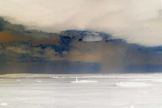 From high up in One World Trade Center, a thunderstorm passes over Lower Manhattan - the Statue of Liberty in the clear and heavy rain falling in Bayonne - Tuesday, June 24, 2008 - negative print