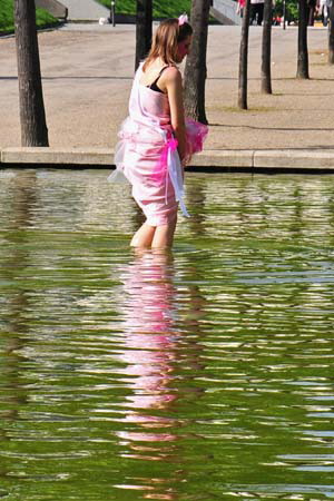 A maiden waded in the water. When she got out she lifted her Greek dress to check the scum level on her white legs. 