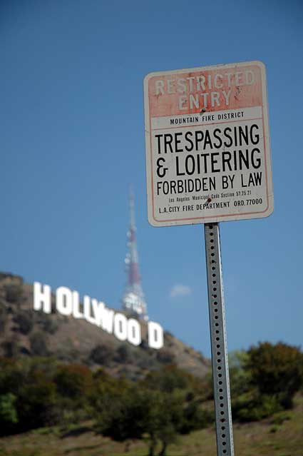 Hollywood sign with warning signs...