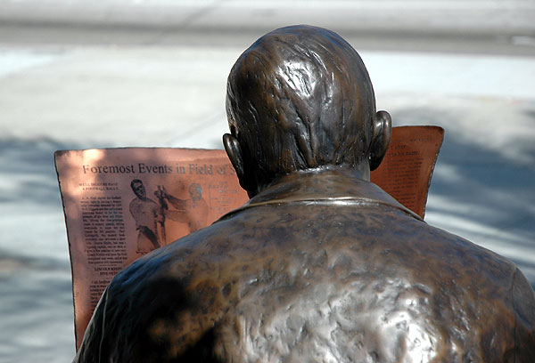 A bronze Harry Culver reads the paper out front -