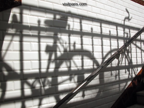 Bicycles are everywhere. Shadows.  Paris.