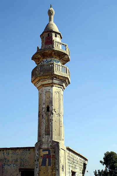 A battered mosque, a remnant from the last war...